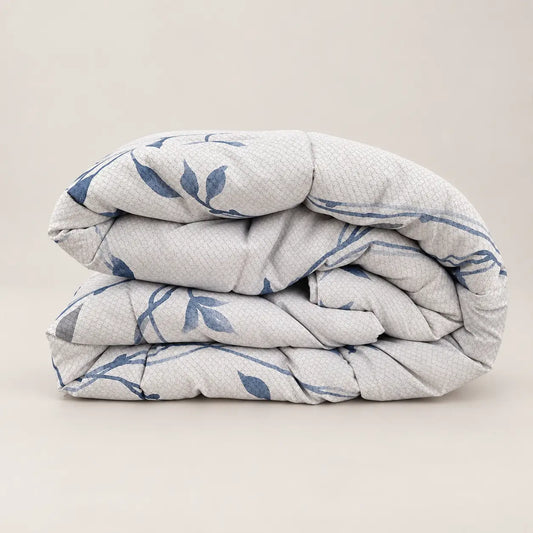 Vue de profil de la couette 250 g/m², soulignant son volume léger et le contraste entre ses deux faces imprimées.