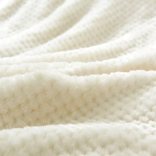 Off-white fleece blanket.